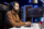 IT developer hearing podcasts while fixing vulnerabilities in software enabling hackers to compromise operating system. Cybersecurity expert enjoying audiobooks, using PC to patch security exposures